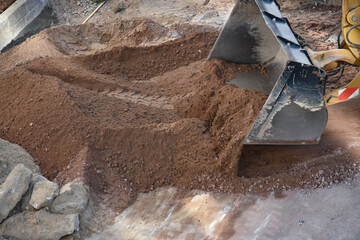 Excavator working on construction site moving soil