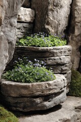 Stacked stone planters, featuring a tiered arrangement of natural stone, showcase a collection of small, delicate flowers.