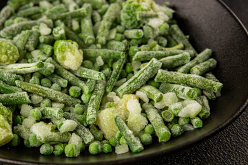 Frozen green vegetables green peas, broccoli, string beans, kohlrabi kale tasty snack fresh delicious gourmet food background on the table rustic food top view copy space vegan and vegetarian food