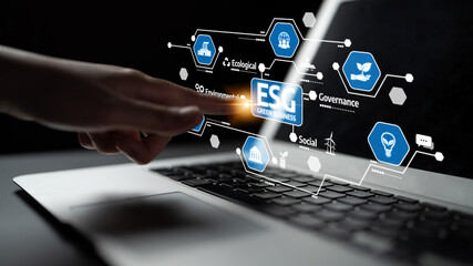 A hand interacts with a modern laptop screen displaying ESG concepts, highlighting the importance of sustainability in business practices and technology integration. Tessel