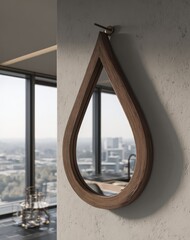 A teardrop-shaped mirror with a warm, wooden frame hangs on a light beige wall, reflecting a cityscape view.