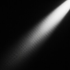 A beam of light shining on a dark wall, creating a stark contrast.