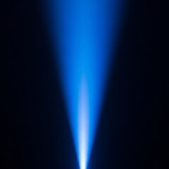 A vibrant blue light beam shines upwards from a dark background, creating a dramatic and ethereal effect with a soft glow.