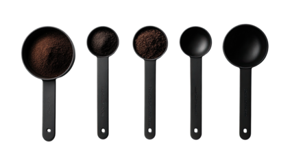Dark coffee grounds in measuring cups