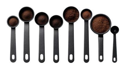 Dark coffee powder in graduated measuring spoons