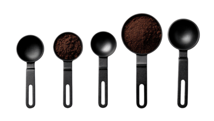 Five black coffee measuring spoons, various sizes, filled with ground coffee