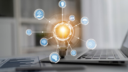 A creative light bulb symbolizes innovative ideas surrounded by technology icons, representing digital transformation in a modern workspace. Perfect for business themes. Crux