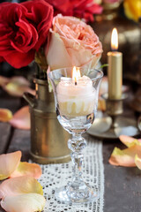 Romantic table decoration with roses and candles. Valentine's Day decorating ideas.