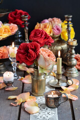 Fototapeta premium Romantic table decoration with roses and candles. Valentine's Day decorating ideas.