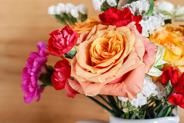Wonderful bouquet with roses, carnations and limonium flowers. Floral arrangements in rustic style.