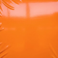 Glossy orange latex fabric background with smooth, reflective surface and vibrant highlights. The material glows under light, creating a bold, energetic, and futuristic aesthetic. Ideal for fashion