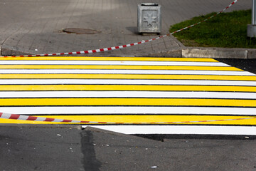 Please exercise caution There is a freshly painted zebra crossing that is equipped with barriers