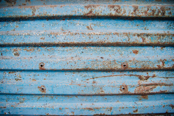 The surface of the metallic blue background. Old metal with worn paint.