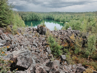 A rocky hillside with a lake in the distance
