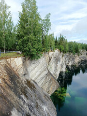 A cliff with a body of water in front of it.