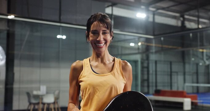 Face, padel and woman with racket, smile and confidence with wellness, pride and funny. Laughing, tennis player and mature person in court, training and practice with exercise, health and fitness