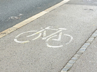 Bicycle lane symbol on urban sidewalk: promoting safe cycling pathways
