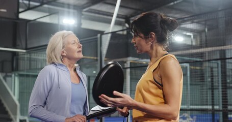 Fitness, women and conversation on court for padel tournament, game or sportsmanship. Athletes, mature people and team with discussion at health club for friendly match, competition or challenge