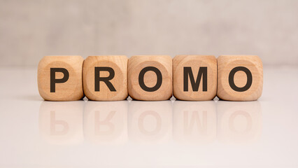 Wooden blocks with PROMO word on reflective white desk