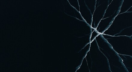 A dark, icy surface displays a complex network of bright, white and blue cracks radiating from a central point, creating an abstract pattern with ample copy space on the left side.