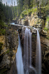 Waterfall Cascading Over Rocks in Forest