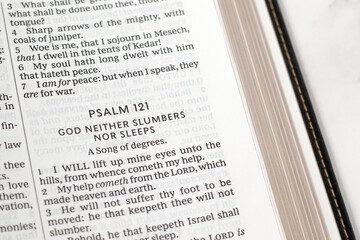 Psalm 121 for God's help, care and protection in open holy bible book. Christian biblical concept.