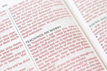 Obraz premium Inspirational christian text for worry and faith in God Jesus Christ in open holy bible book.