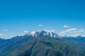 Mountain summit in the Alps in spring with little snow. Copy space.