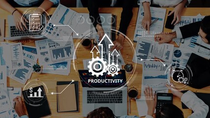 A dynamic team collaboration meeting in a modern office setting, focusing on productivity strategies. Graphs and charts illustrate data analysis and business planning activities. Raster - Powered by Adobe