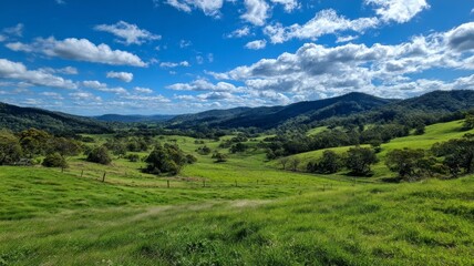 Fototapeta premium Rolling hills with blue sky and mountains. AI image