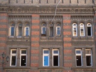 Old architectural facade with ornate brickwork and windows in Tbilisi, Georgia  
