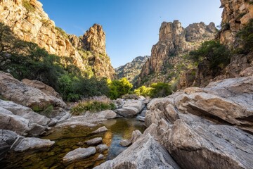 Rocky Canyon Valley With Creek And Sunlight