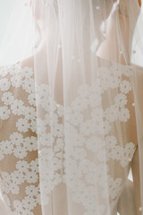 Bridal veil at a wedding ceremony, elegant detail of a bride’s outfit symbolizing love, purity and tradition, classic element of marriage fashion and celebration