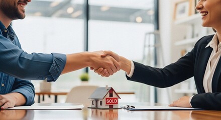 Real Estate Deal Handshake Over House Model, Contract, and Keys on Office Desk – Home Sale Agreement with Agent and Client Concept