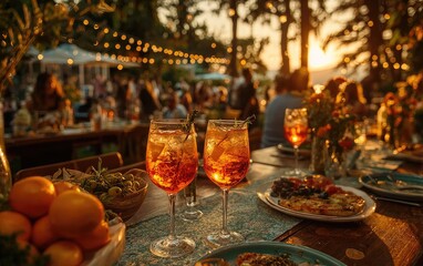 Two Drinks on Table with Fruits and Plates at Sunset Celebration