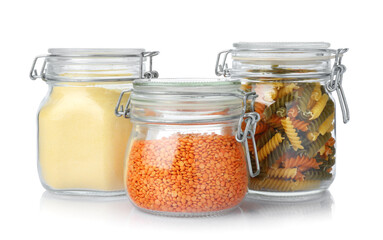 Glass jars with different products isolated on white