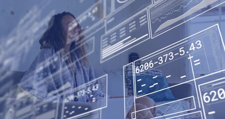 woman powering up laptop on sofa and scrolling data panels, analyzing technology metrics