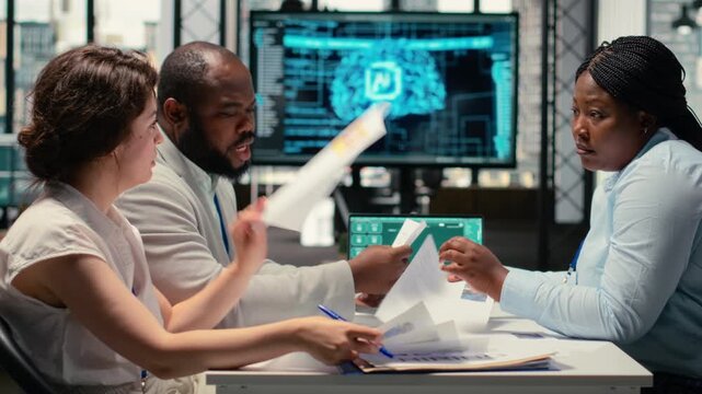 Recruiters reviewing feedback from artificial intelligence platform, using automation and deep learning to make informed hiring decisions and select suitable applicants for employment. Camera B.
