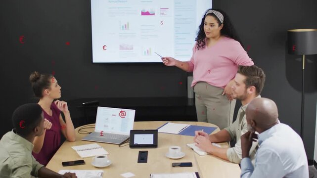 Marketing lead pointing at screen and explaining financial charts updating to inform team decisions