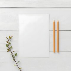 Flat lay of blank white paper sheet with two yellow pencils and green leaf branch on white wooden background, perfect for mockup, branding, message design, natural minimal workspace, or creative layou