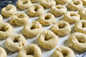 Rising homemade donut dough on floured surface in cozy kitchen