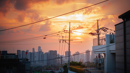 A red sunset over the city seen from the foot of Namsan Mountain in Seoul, South Korea
