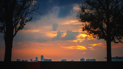 A red sunset over the city seen from the foot of Namsan Mountain in Seoul, South Korea
