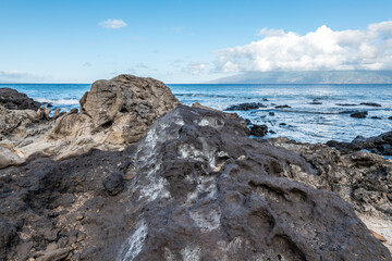 Breccia is a rock composed of large angular broken fragments of minerals or rocks cemented together by a fine-grained matrix. Napili Bay, West Maui, Hawaii.
