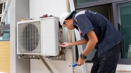 Professional HVAC Technician Inspecting and Repairing Outdoor Air Conditioning Unit, Mechanic Fixing and Maintenance AC Compressor with Tools, Worker Checking Electrical Components of Air Conditioner