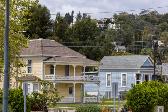 Cloudy afternoon sun shines on historic homes in the heart of downtown Santa Paula, California, USA.