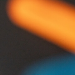 abstract background with orange and blue noisy light rays