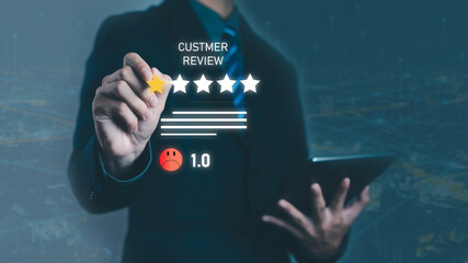 Businessman hand holding digital star rating with low customer review feedback score 1.0, unhappy client experience, poor service evaluation, online reputation and consumer dissatisfaction.