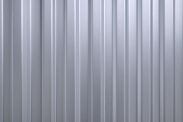 Obraz premium Silver Metallic Corrugated Metal Sheet Background with Vertical Lines, Reflective Surface and Industrial Texture