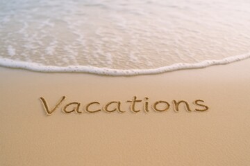 Fototapeta premium Vacations Written in Sand on a Tropical Beach with Gentle Wave Approaching, Suggesting Relaxation and Leisure